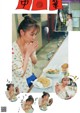 A woman sitting at a table eating a bowl of food.