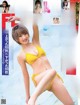 A woman in a yellow bikini on the cover of a magazine.