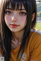 A girl with long black hair wearing a yellow shirt.